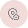 A circular icon showing a location pin with a small house inside, representing an address or home location.