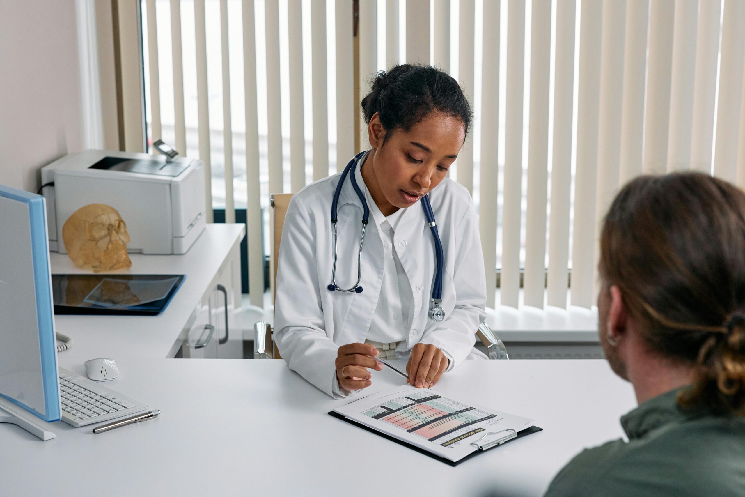 Female consultant speaking with a patient at a gynaecology clinic in Birmingham in a private setting