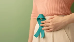 Woman holding teal ribbon symbolising cervical screening awareness in Birmingham